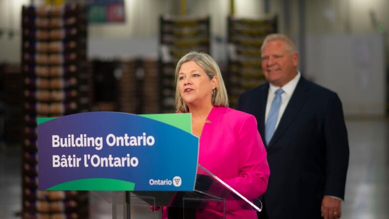 A woman standing at a podium/