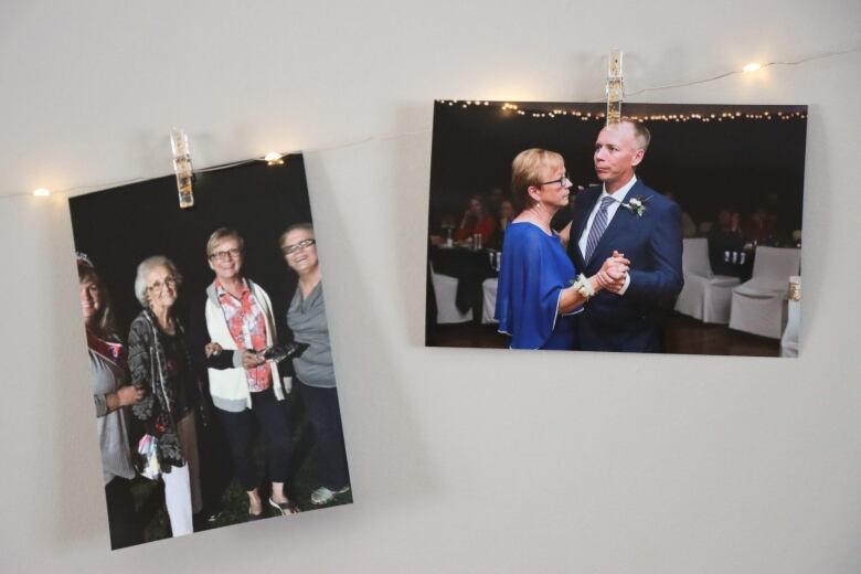 Family photographs are strung up along twinkle lights. 