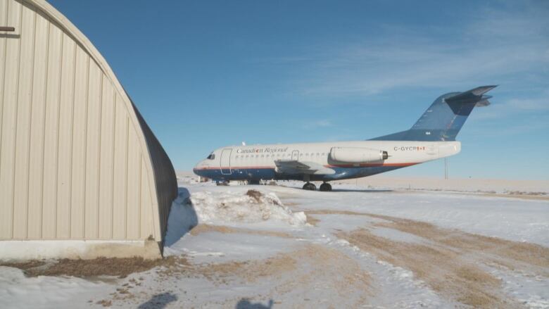 A large airplane sits in a field.