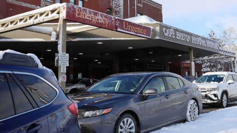 The front entrance of a large brick building is shown with a sign saying emergency Cape Breton Regional Hospital.