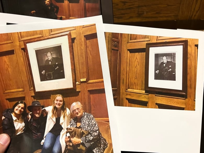 Two photos showing a framed black and white photograph of a scowling man are shown on a wood-panelled wall. One photo includes a group of people posing with the photograph.