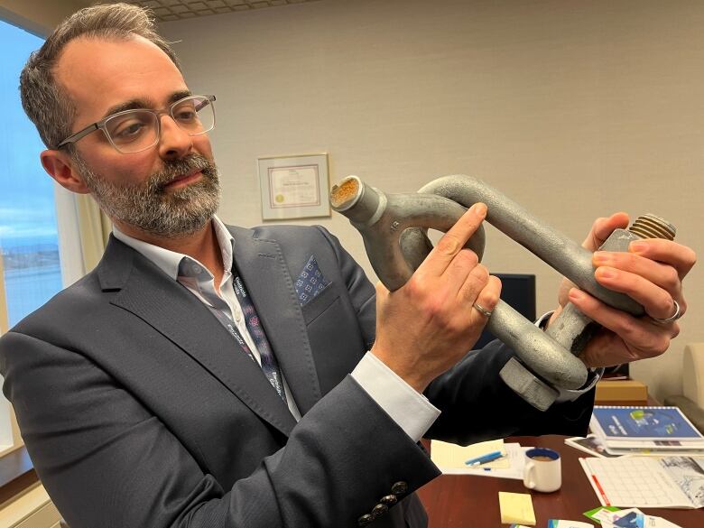 A Hydro executive displays a broken steel utility connector.