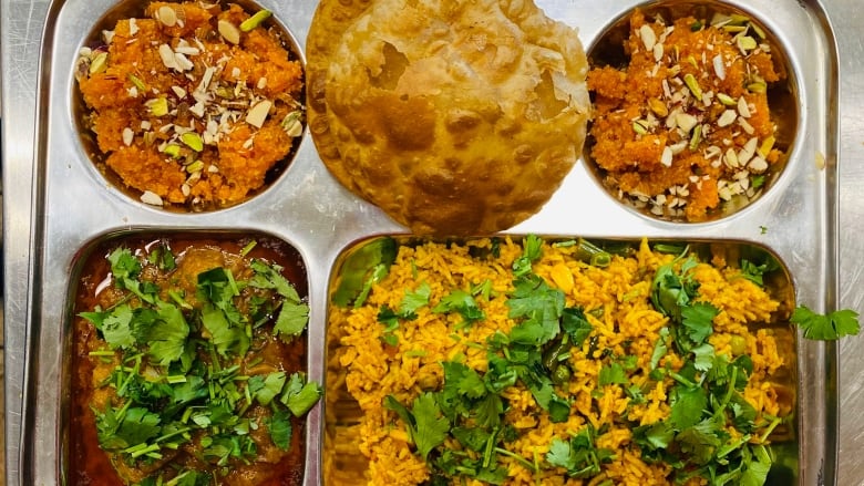 A tray with several different foods on it.