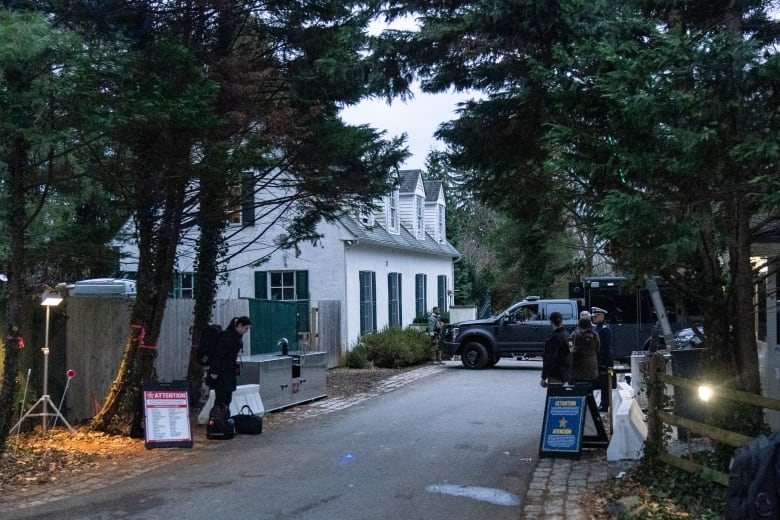 People are seen outside a home.