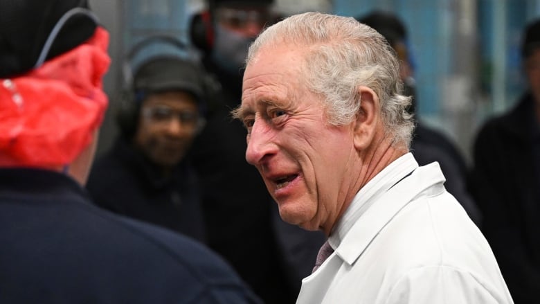 King Charles is seen entering a building.