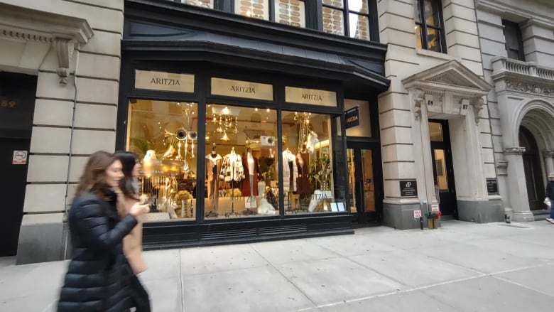 Pedestrians walk past the Canadian retailer Aritzia's location in New York City's Flatiron District on Jan. 21, 2023. 