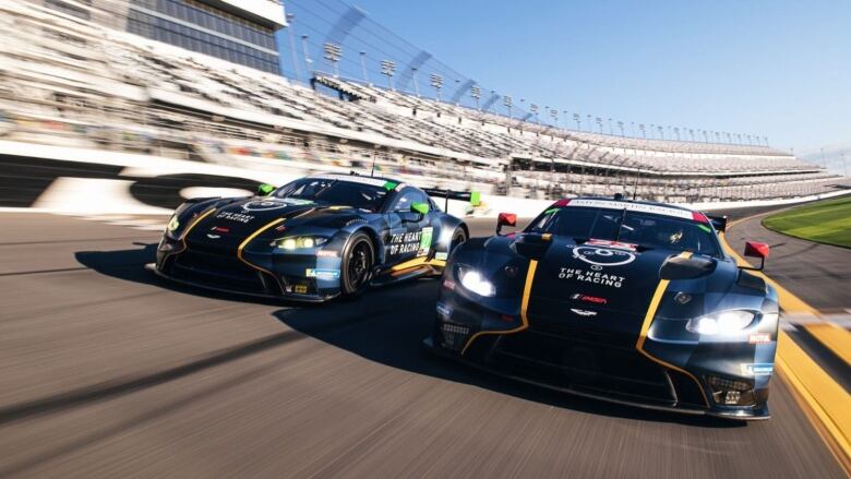 Two race cars going wheel-to-wheel