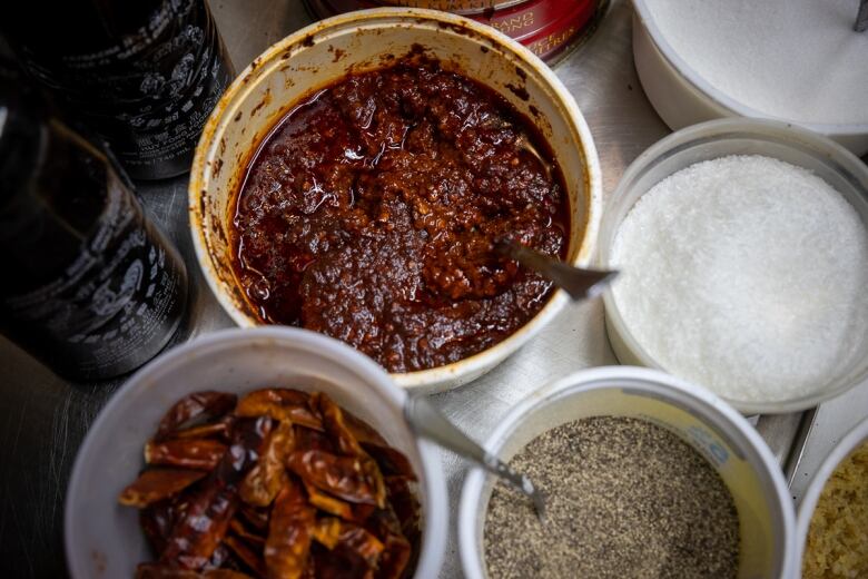 A variety of ingredients in bowls, including Wong's house made chili sauce. 