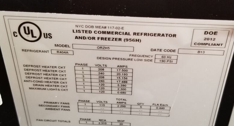 A label inside a refrigerator shows information such as the type of refrigerant.