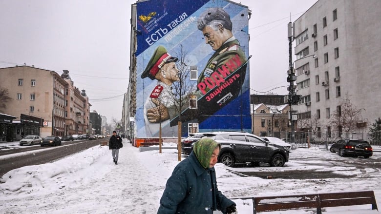 A mural in Moscow promoting military service shows an illustration of a Russian general and a cadet.