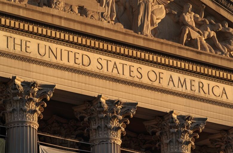 The stone facade of a building, with the etched words 'The United States of America.'