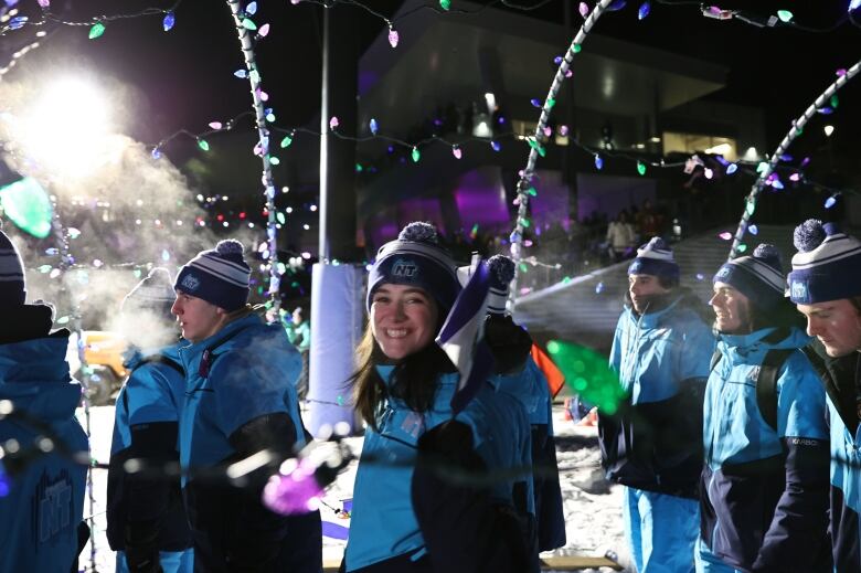 Athletes enter the MacDonald Island Park in Fort McMurray, Alta., for the Arctic Winter Games opening ceremony.