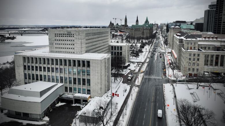 A downtown city street in winter, seen from above.