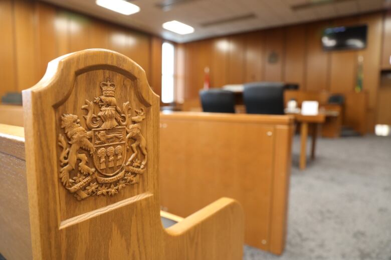 File - The Coat of arms of Saskatchewan on a bench in an empty courtroom at Saskatoon Court of King's Bench.