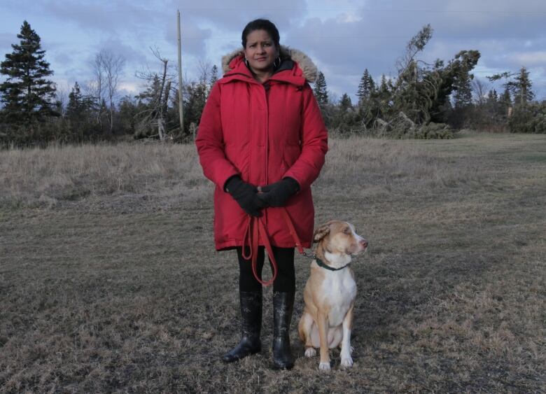 person standing with their dog 