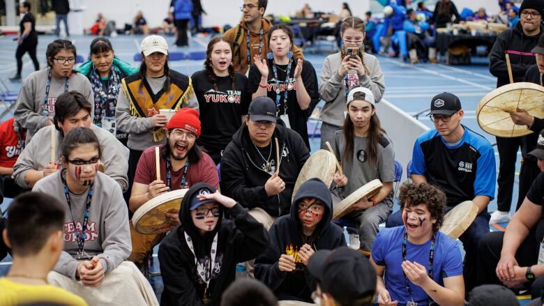 Competitors take part in the Dene hand games event.