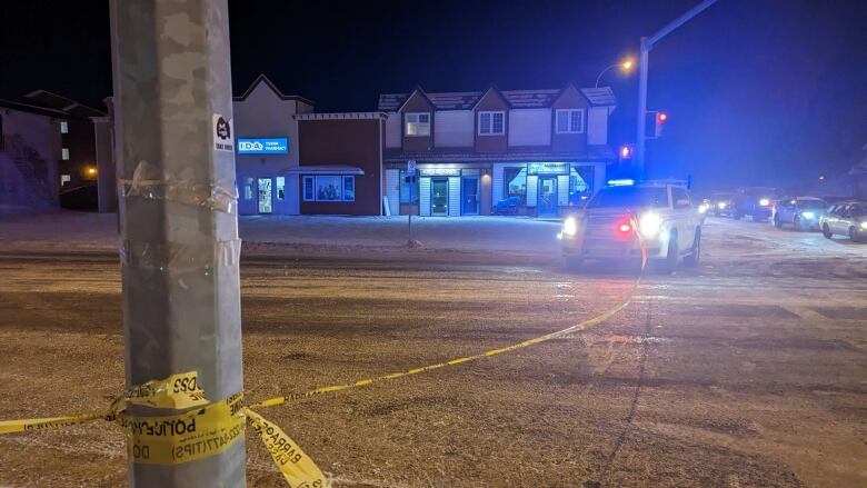 Police tape on a dark street