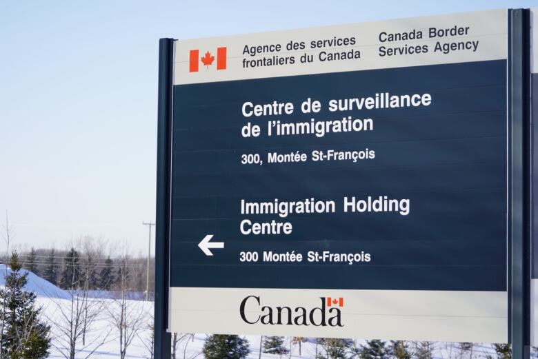 Sign for immigration detention centre in winter landscape.