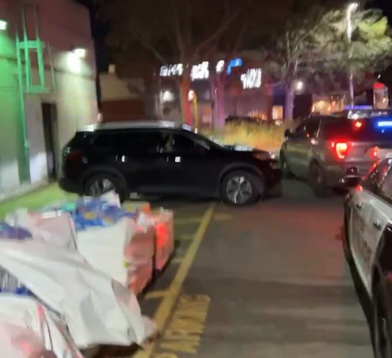 Halton police look through the stolen car behind a Petro-Canada gas station in Oakville.