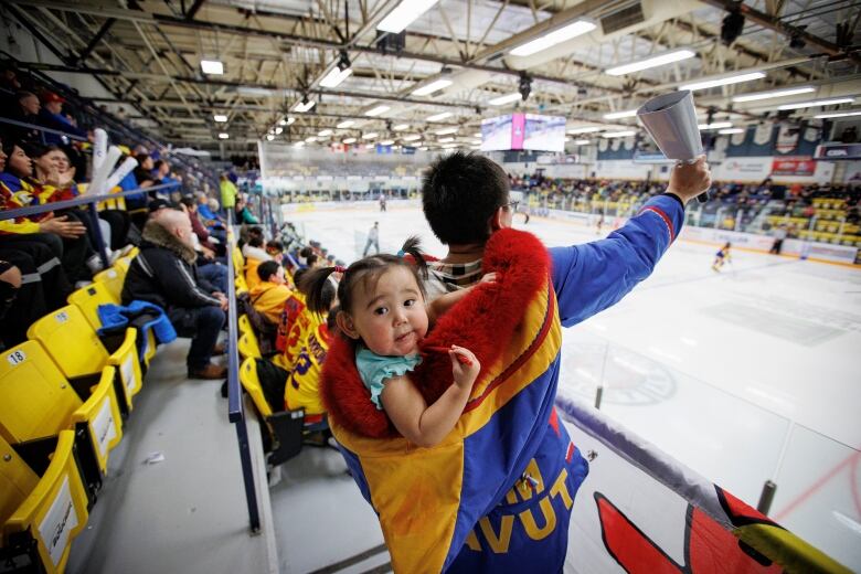 Fans in the bleachers root for Team Nunavut and Team Alaska playing in the final of the Arctic Winter Games