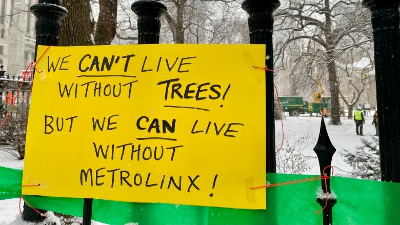 A sign is pictured near Osgoode Hall as Metrolinx begins the removal of centuries-old trees early Saturday morning.