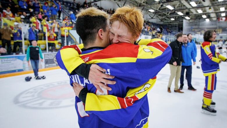 Members of Team Nunavut embrace after winning the final game of hockey at the Arctic Winter Games.