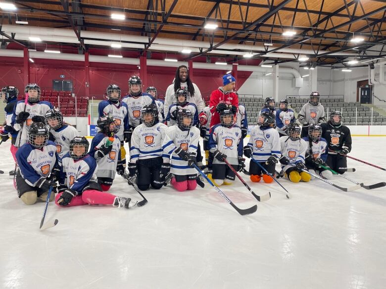 Hockey players are posing for a photo.