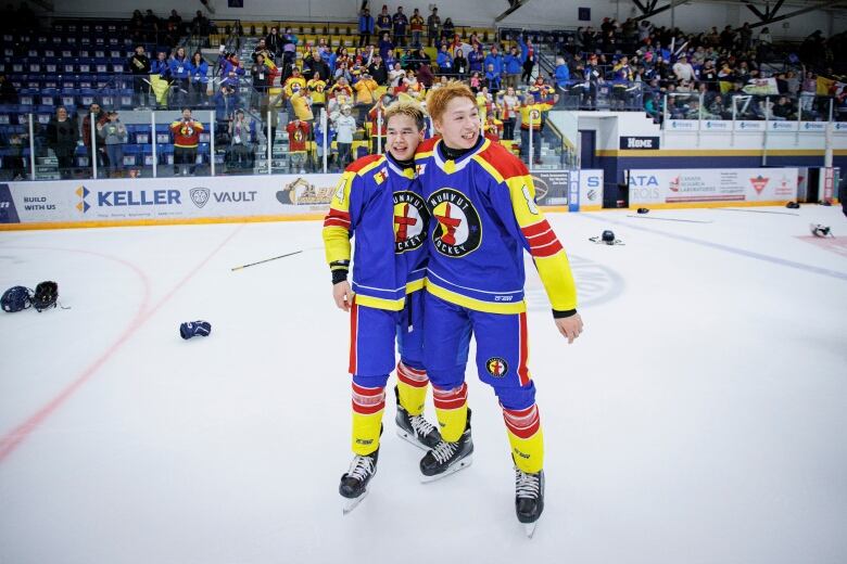 Two players on the ice, in awe.