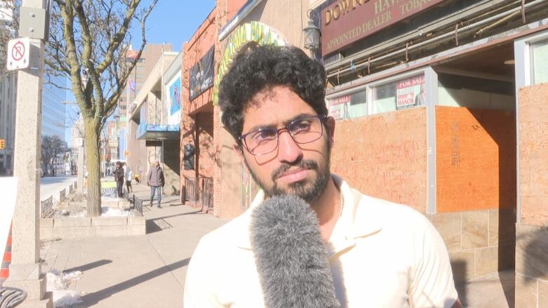 A man with glasses and microphone. 