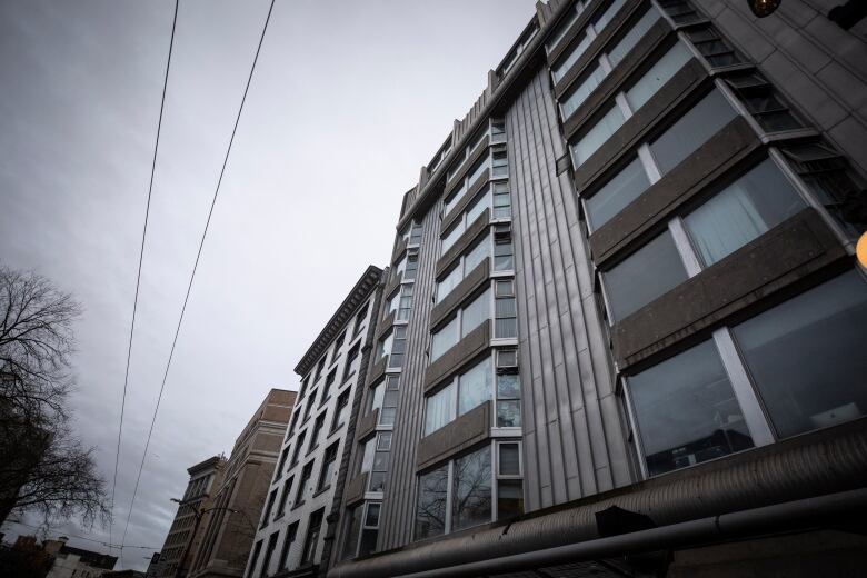 A building with nine floors is seen from the ground looking up.