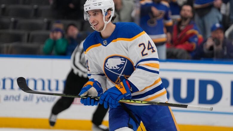 Smiling hockey player on ice.