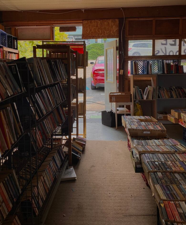 An interior view of a garage filled with books on shelves.