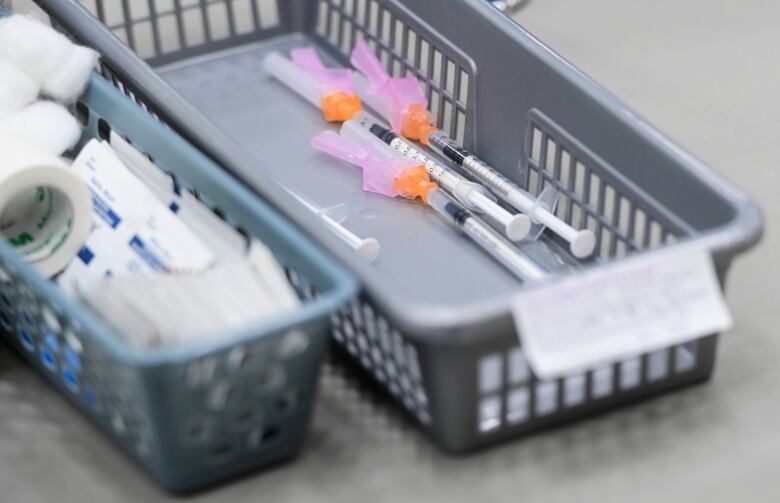 A file photo shows a basket of COVID-19 doses, waiting to be administered to patients, at an Ottawa clinic, in March 2021.