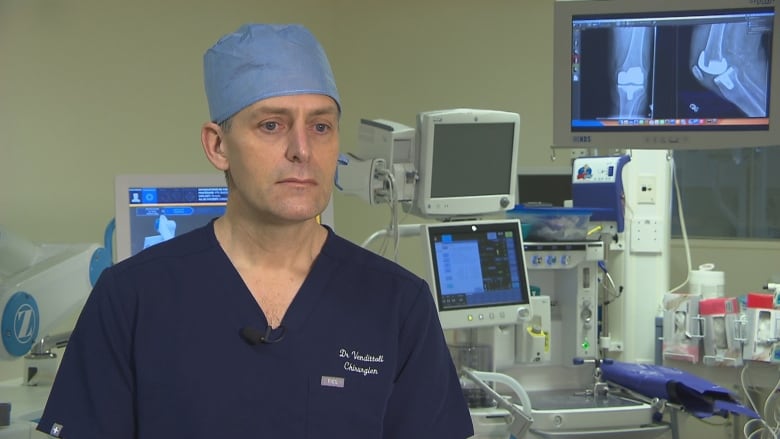 Dr. Pascal-Andr Vendittoli is pictured in surgical scrubs in an operating room at the Duval Clinic. 