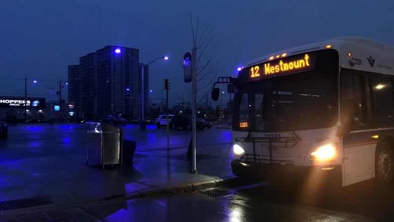 blue and purple light behind a GRT transit bus