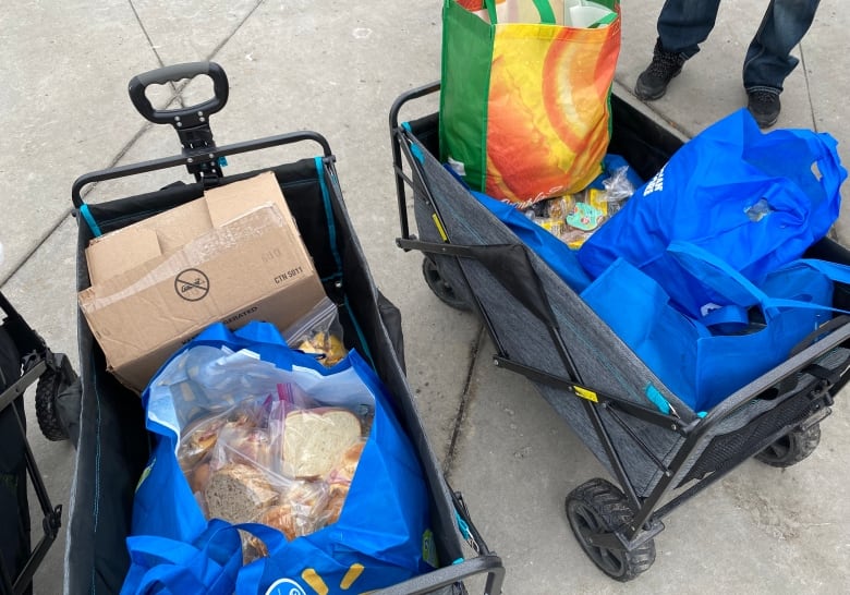 Two carts full of sandwiches and supplies.