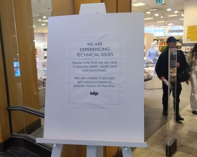 A sign at an Indigo store in Toronto informing customers that debit and credit systems are working, but gift card payments are not.