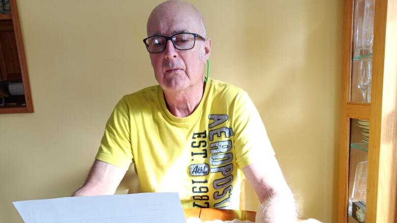 Ron Flynn of Alberton reads the letter he received informing him that his family physician, Dr. Hal McRae, would be closing his Summerside practice on April 20.