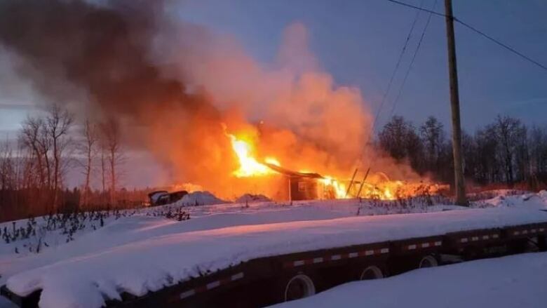 A building with flames shooting out of it.