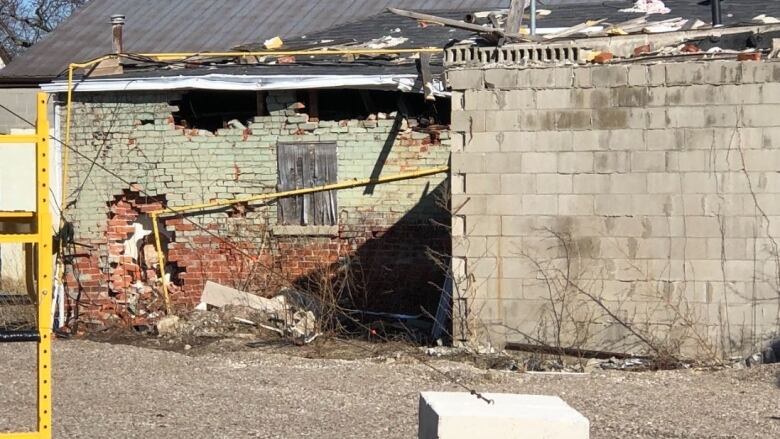 A damaged house with bricks missing