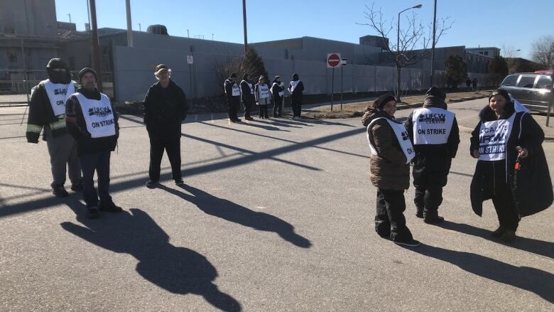 A group of workers wearing shirts that say 