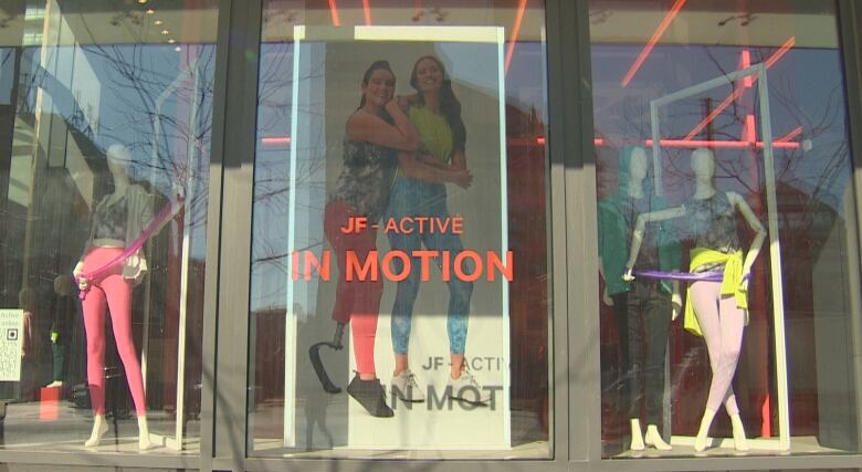 Picture of the front window at Loblaws. Allison Lang is posing in athletic clothes with her prosthetic leg on a large poster.