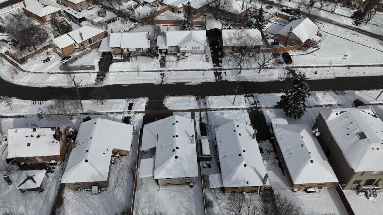 An aerial shot of snow-covered houses.