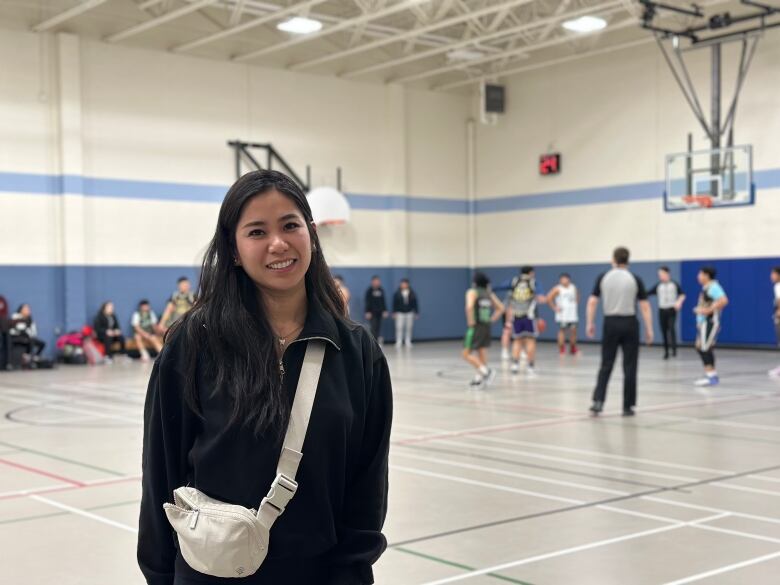 person with basketball game in the background 