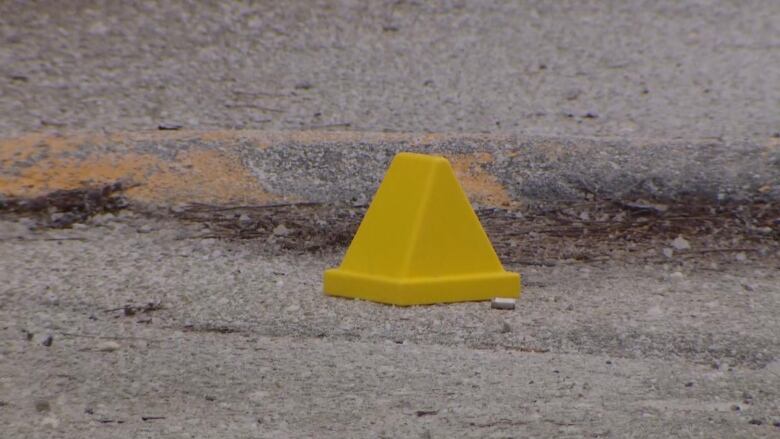 A bullet casing is seen on the ground outside a Toronto school where a shooting took place on Feb. 16.