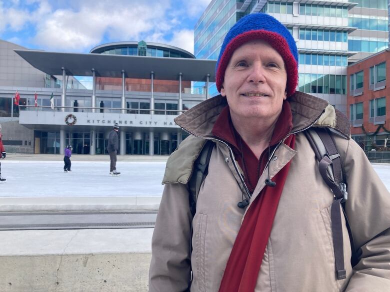 Windsor Viney is standing in front of Kitchener City Hall. 