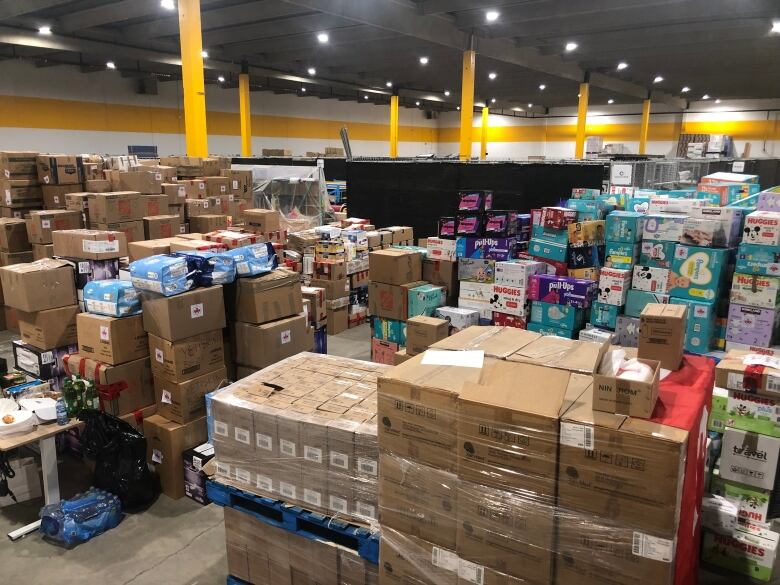 Stacked boxes are pictured in a warehouse.