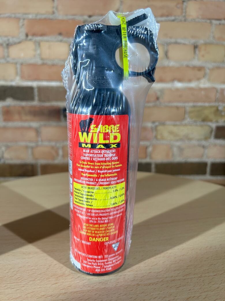 A red spray canister with the words Sabre Wild Max written on it is shown.