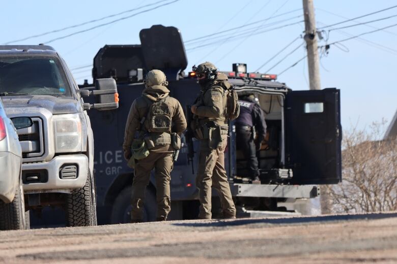 Heavily armed RCMP officers could be seen outside a home on 74th Street in Eskasoni on February 22, 2023. 