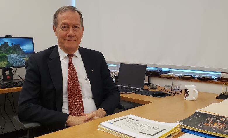 A man sitting at a desk.